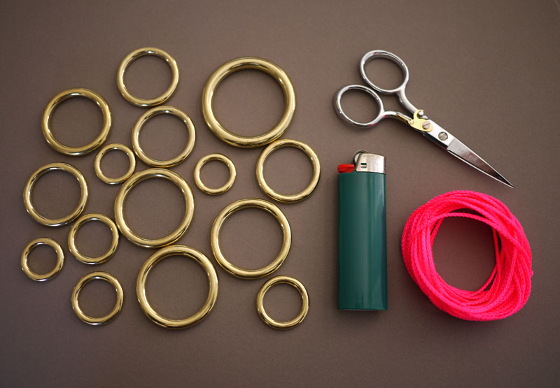 various sized brass rings. neon nylon mason line cord. scissors. lighter. 