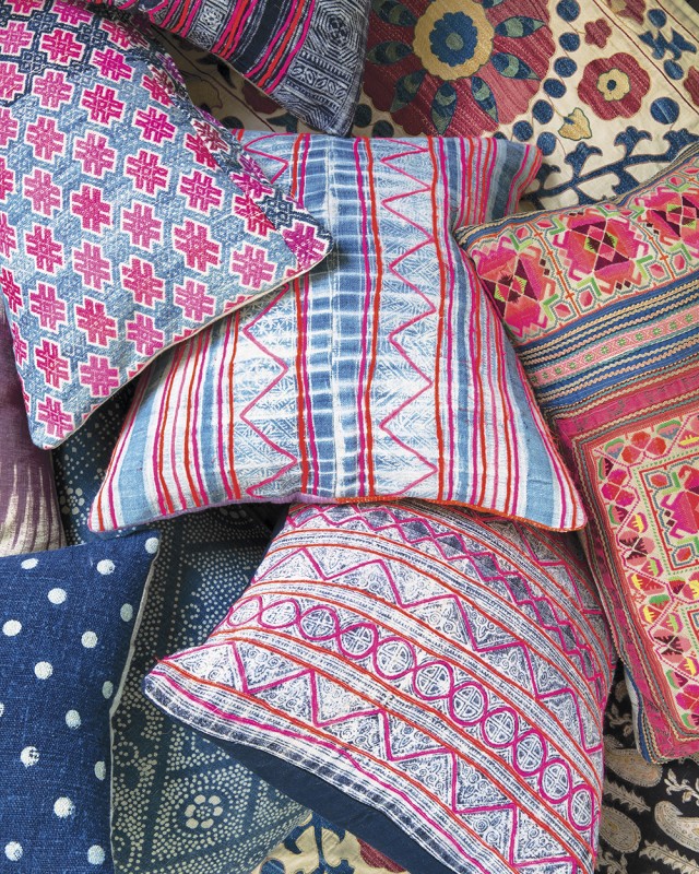 Brightly colored pillows layered on top of one another